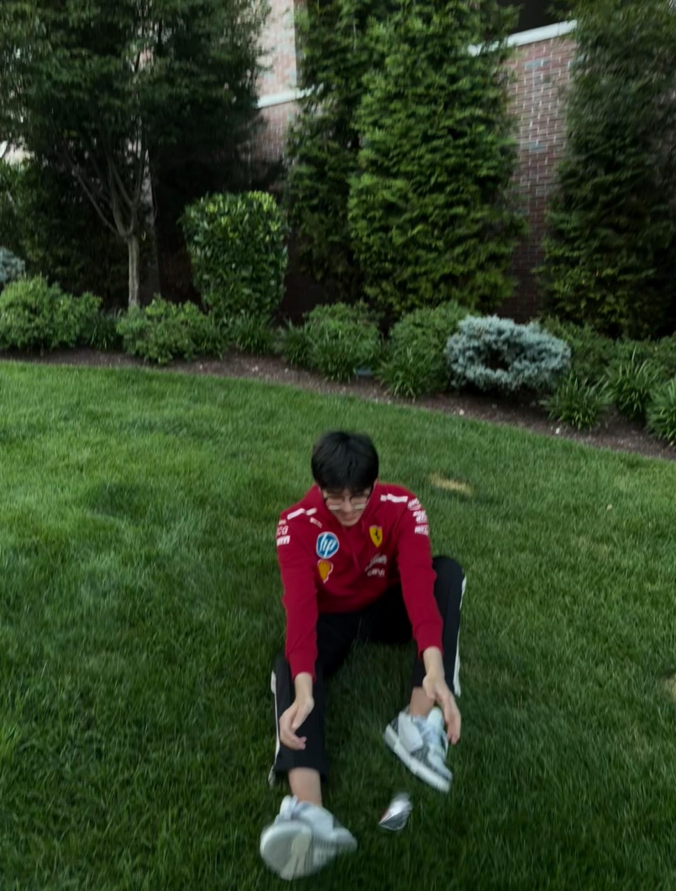 Wearing a red shirt, a fragment of life sitting on the grass.