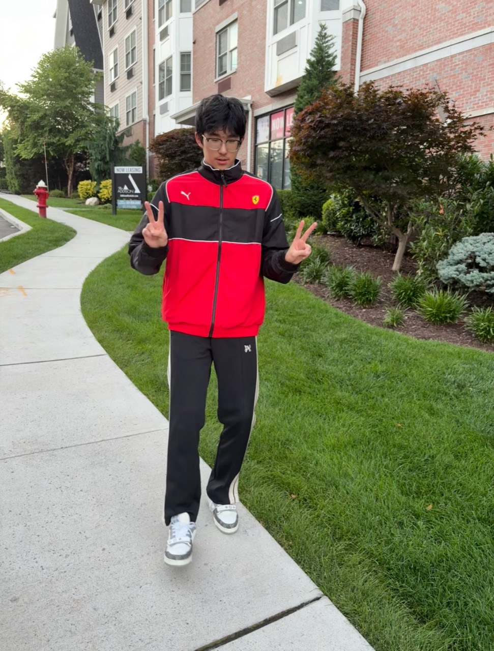 Wearing a red and black sports coat, he gestured in front of the camera.